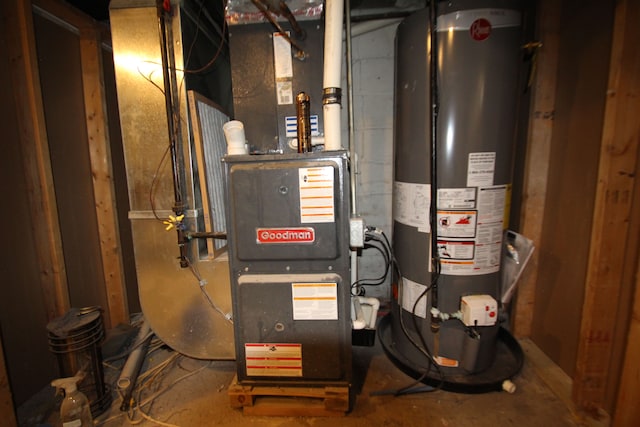 utility room featuring heating unit and gas water heater