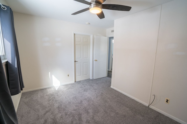 unfurnished bedroom featuring a ceiling fan, carpet floors, and baseboards