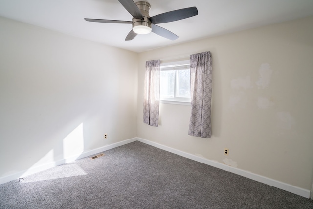 spare room with baseboards, visible vents, carpet flooring, and a ceiling fan