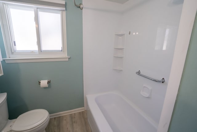 full bath with toilet, wood finished floors, and baseboards