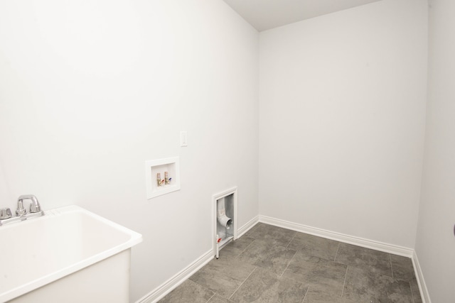 laundry room with laundry area, hookup for a washing machine, baseboards, and a sink