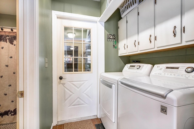 laundry room with cabinets, washing machine and dryer, and light tile patterned floors