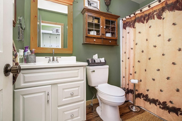 bathroom with vanity, hardwood / wood-style flooring, toilet, and walk in shower