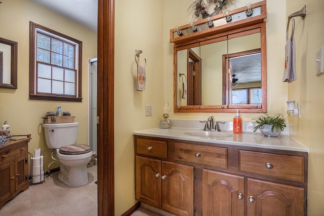 bathroom featuring vanity, toilet, and a wealth of natural light