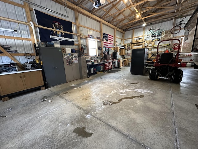 garage with a garage door opener and a workshop area