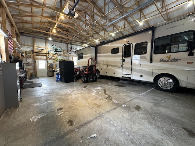 garage featuring a garage door opener and black fridge