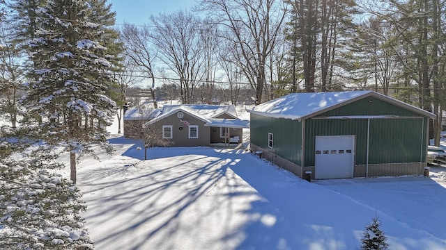 view of front of property featuring a garage and an outdoor structure