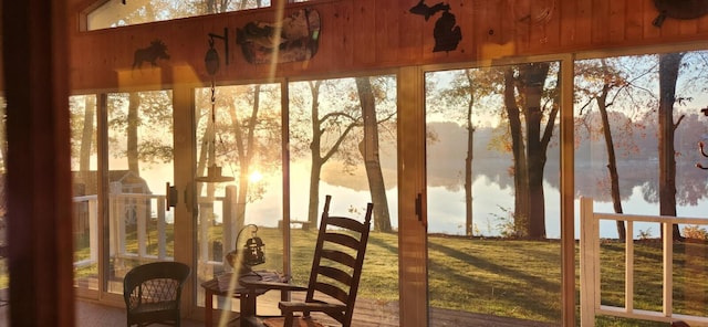 sunroom / solarium featuring a water view