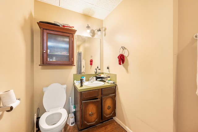 bathroom featuring hardwood / wood-style flooring, vanity, and toilet