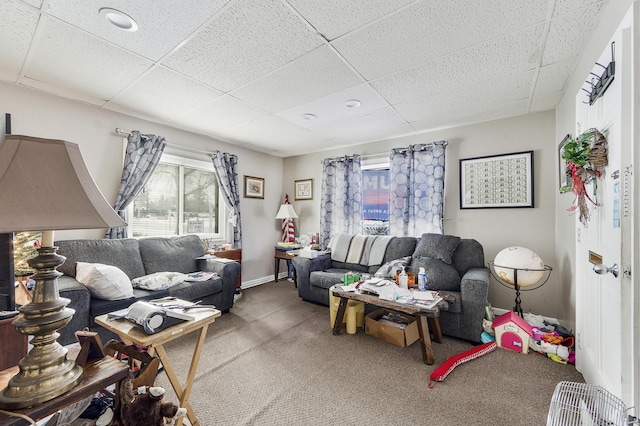 living room with carpet floors and a paneled ceiling