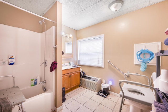 bathroom featuring washtub / shower combination, vanity, and tile patterned flooring