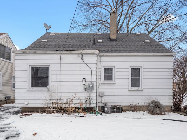 snow covered house with cooling unit