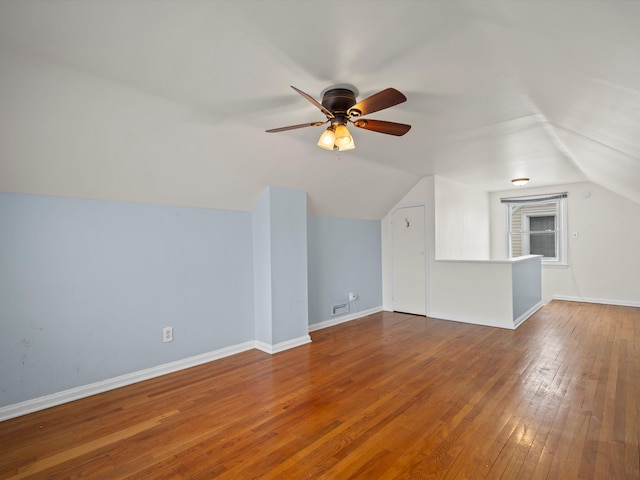 additional living space with lofted ceiling, hardwood / wood-style floors, and ceiling fan