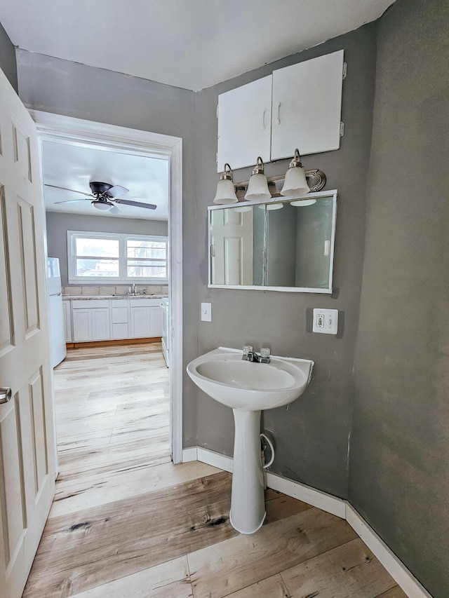 bathroom with sink, hardwood / wood-style floors, and ceiling fan