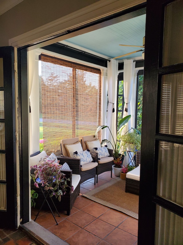 sunroom / solarium featuring ceiling fan