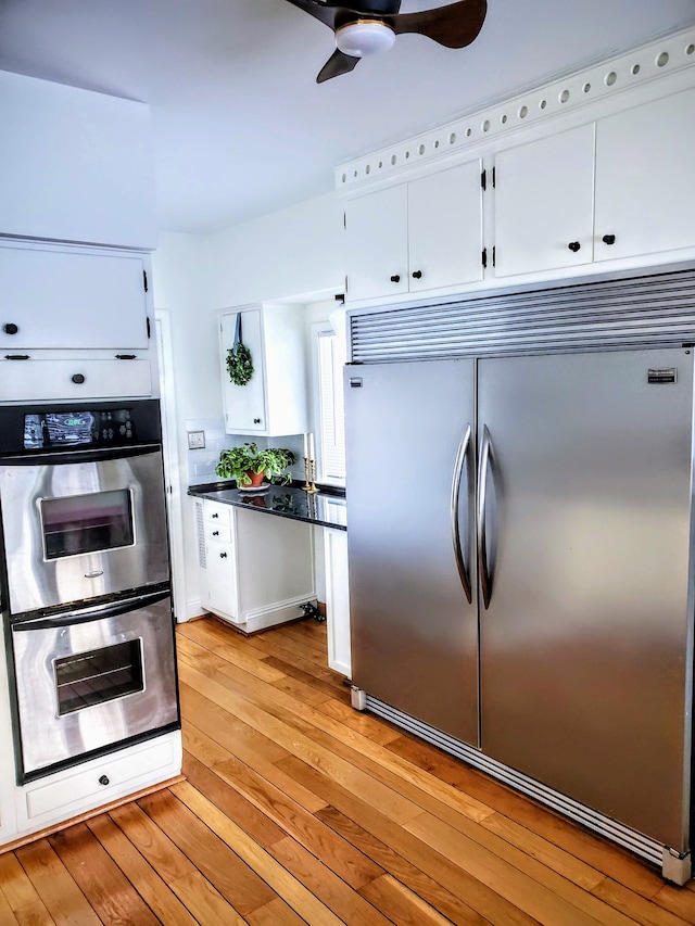 kitchen featuring ceiling fan, light hardwood / wood-style flooring, white cabinets, and appliances with stainless steel finishes