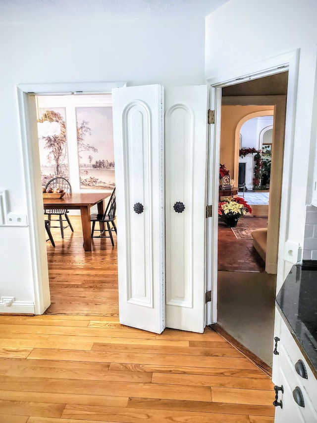 corridor with light hardwood / wood-style floors