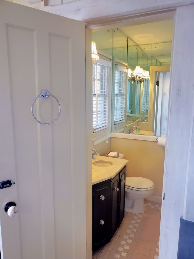 bathroom with vanity, tile patterned flooring, and toilet