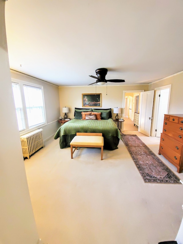 carpeted bedroom featuring radiator heating unit and ceiling fan