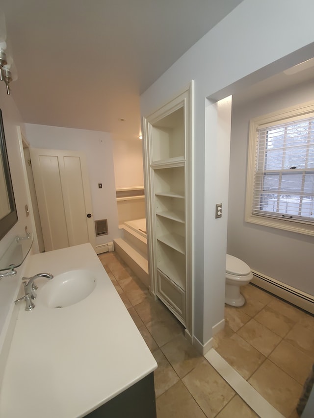 bathroom with tile patterned flooring, vanity, a baseboard heating unit, and toilet