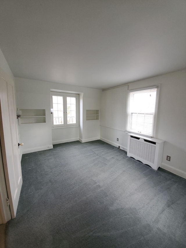 carpeted spare room with radiator