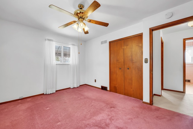 unfurnished bedroom featuring ceiling fan and light colored carpet