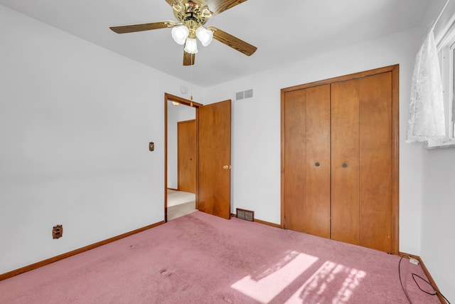 unfurnished bedroom featuring ceiling fan, carpet floors, and a closet