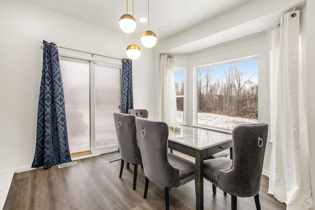 dining area with hardwood / wood-style floors