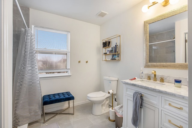 bathroom featuring vanity, tile patterned flooring, toilet, and walk in shower