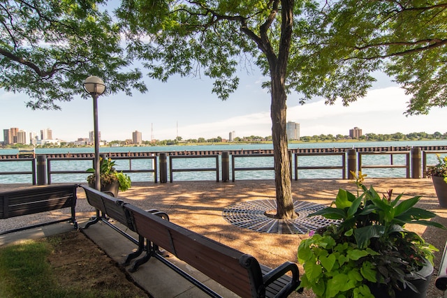 view of dock featuring a view of city and a water view