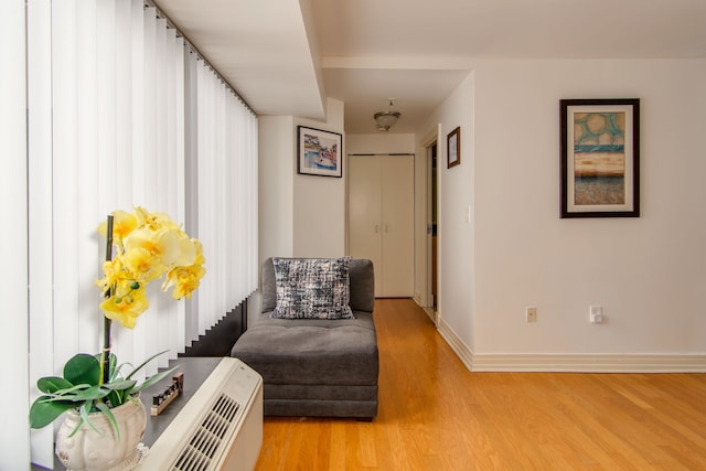 living area featuring light wood-type flooring and baseboards