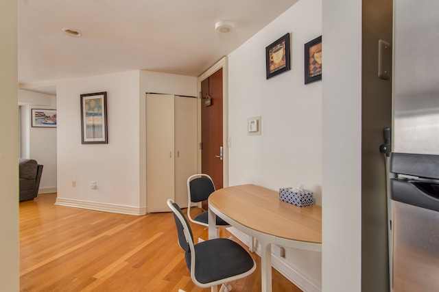 office with light wood-type flooring and baseboards