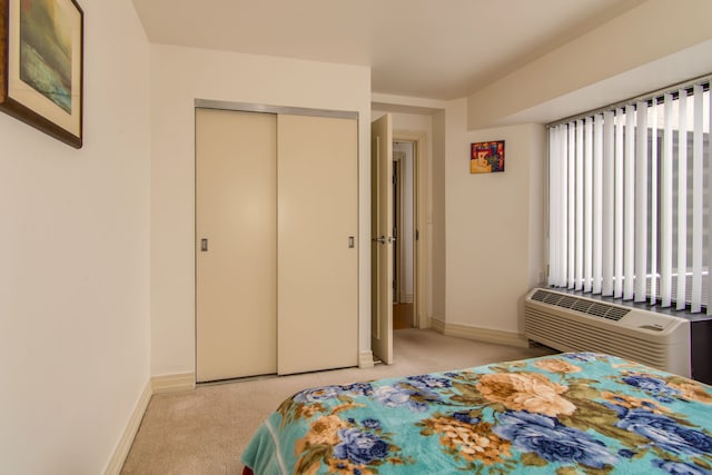 bedroom featuring baseboards, a closet, and light colored carpet