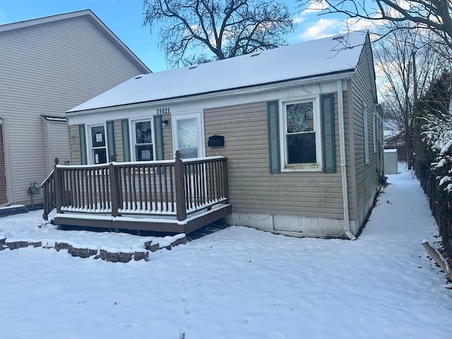 view of snow covered rear of property