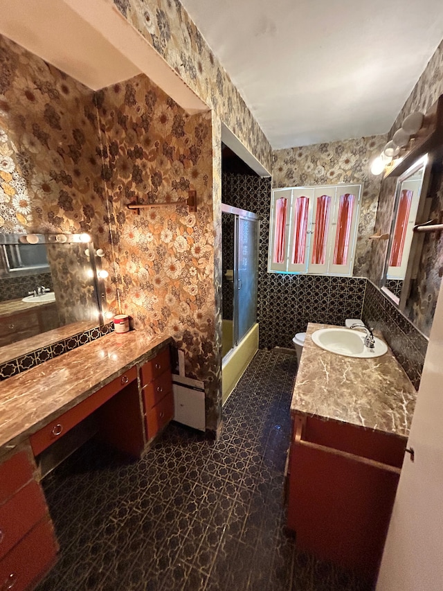 bathroom featuring vanity and combined bath / shower with glass door