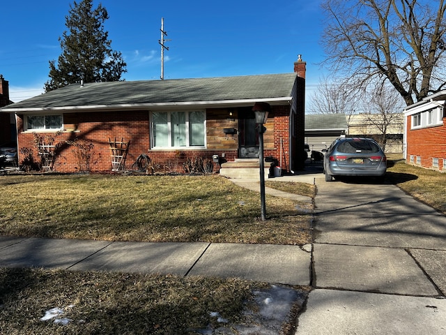 view of front of home featuring a garage and a front lawn