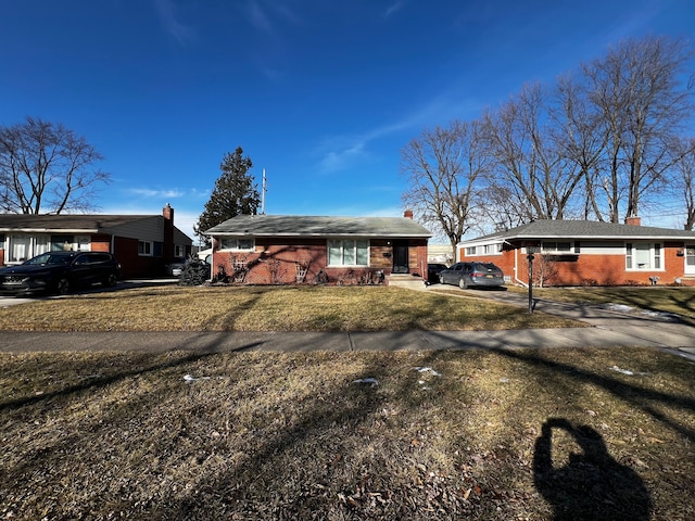 ranch-style home with a front yard and a carport