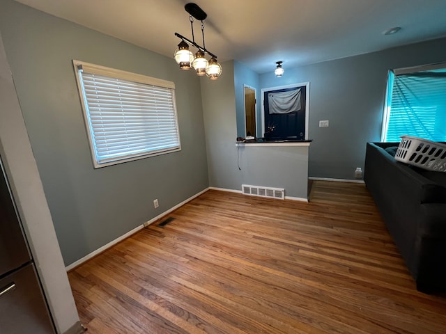 unfurnished dining area with hardwood / wood-style flooring