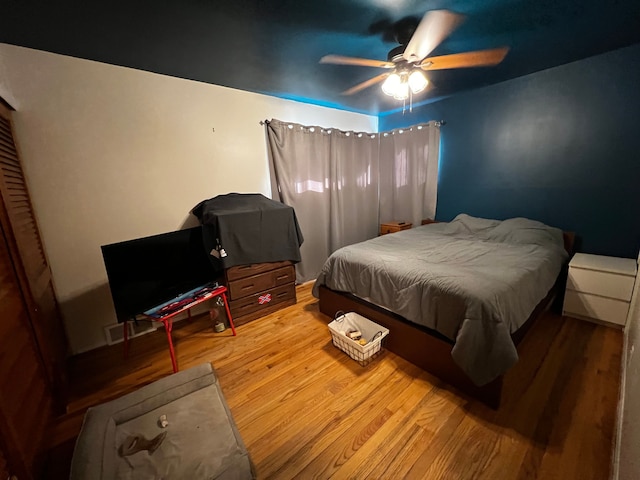 bedroom featuring hardwood / wood-style floors and ceiling fan