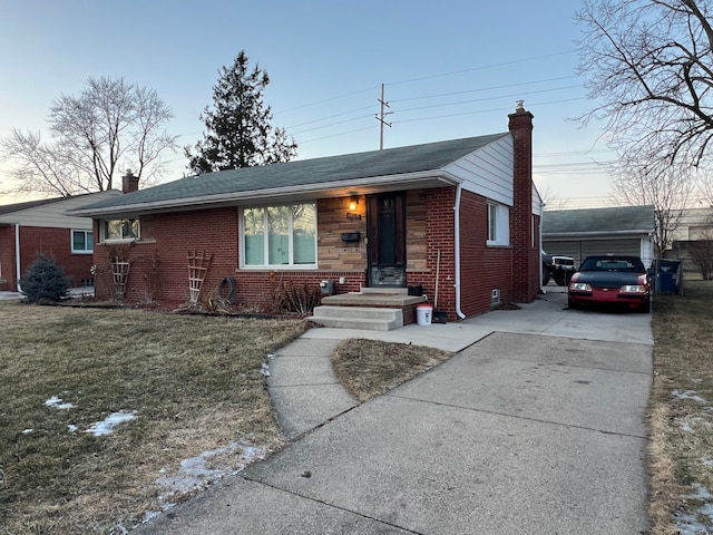 view of front of house featuring a garage, an outdoor structure, and a front lawn