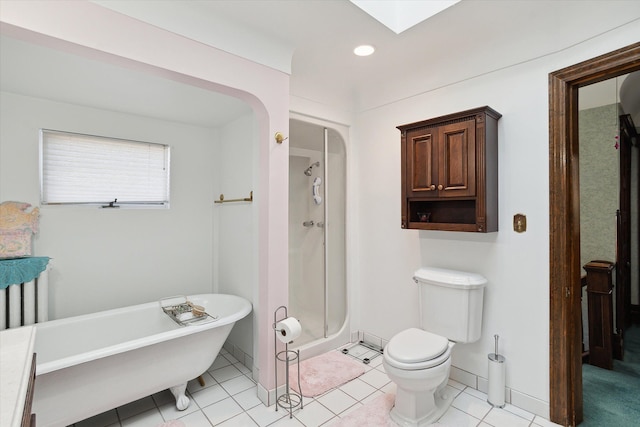 bathroom featuring a skylight, toilet, separate shower and tub, and tile patterned flooring