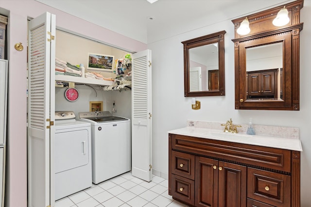 laundry room with washer and clothes dryer and light tile patterned floors