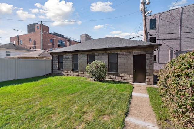 rear view of house featuring a yard