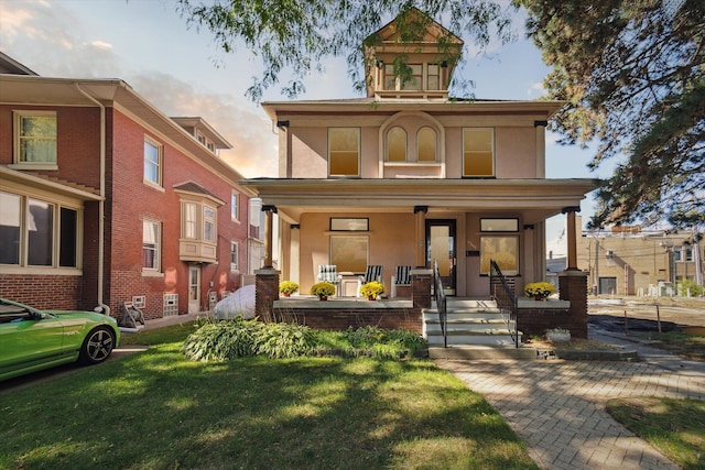 view of front of home with a yard and covered porch