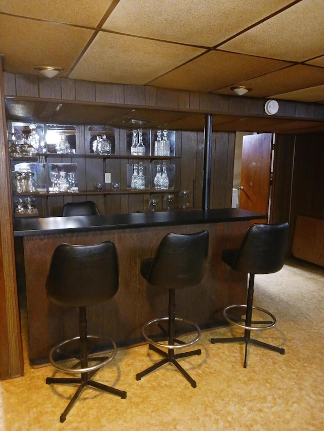 bar with a paneled ceiling and a bar