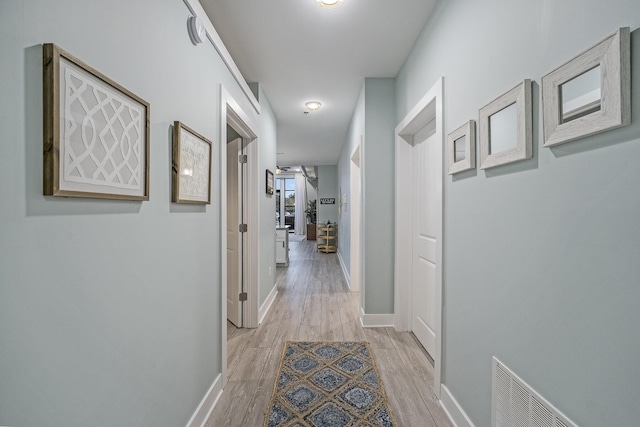 corridor featuring light hardwood / wood-style flooring