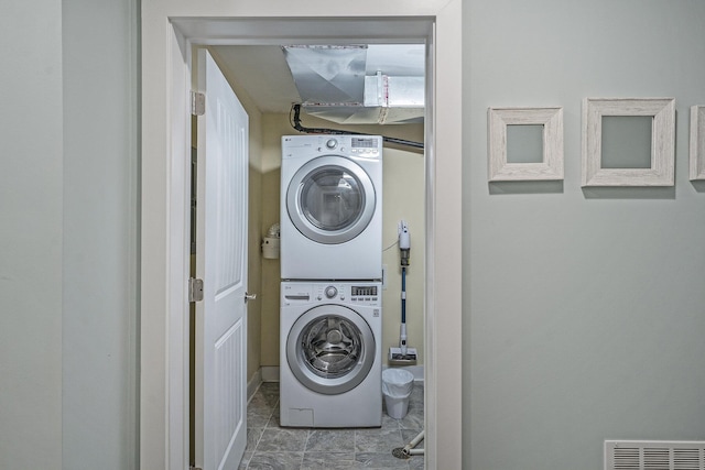 washroom with stacked washer and clothes dryer