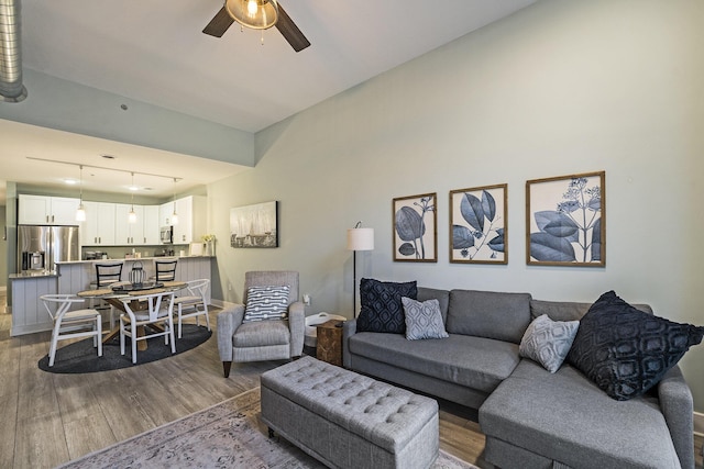 living room featuring ceiling fan and light hardwood / wood-style flooring