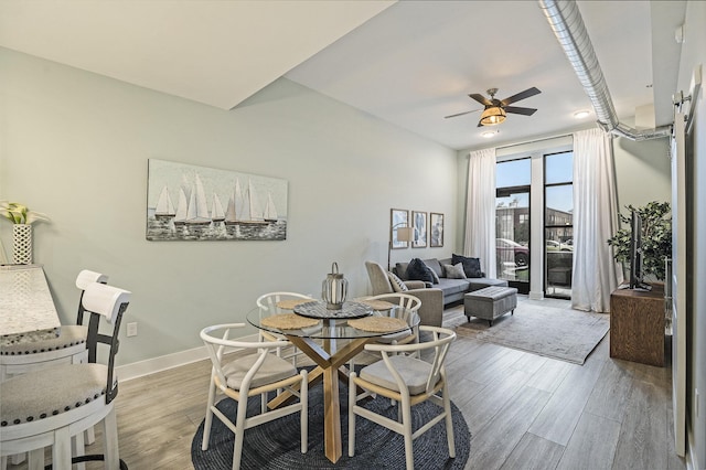 dining room featuring ceiling fan and light wood-type flooring