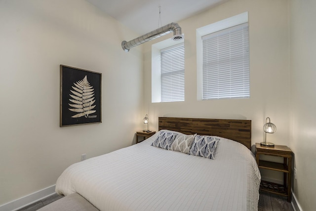 bedroom featuring dark hardwood / wood-style flooring